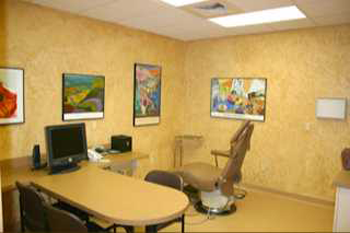 {PRACTICE_NAME} patient consultation room with desk and chairs Wichita KS