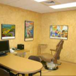 {PRACTICE_NAME} patient consultation room with desk and chairs Wichita KS