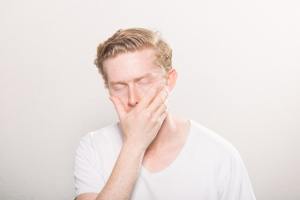 man holding his jaw